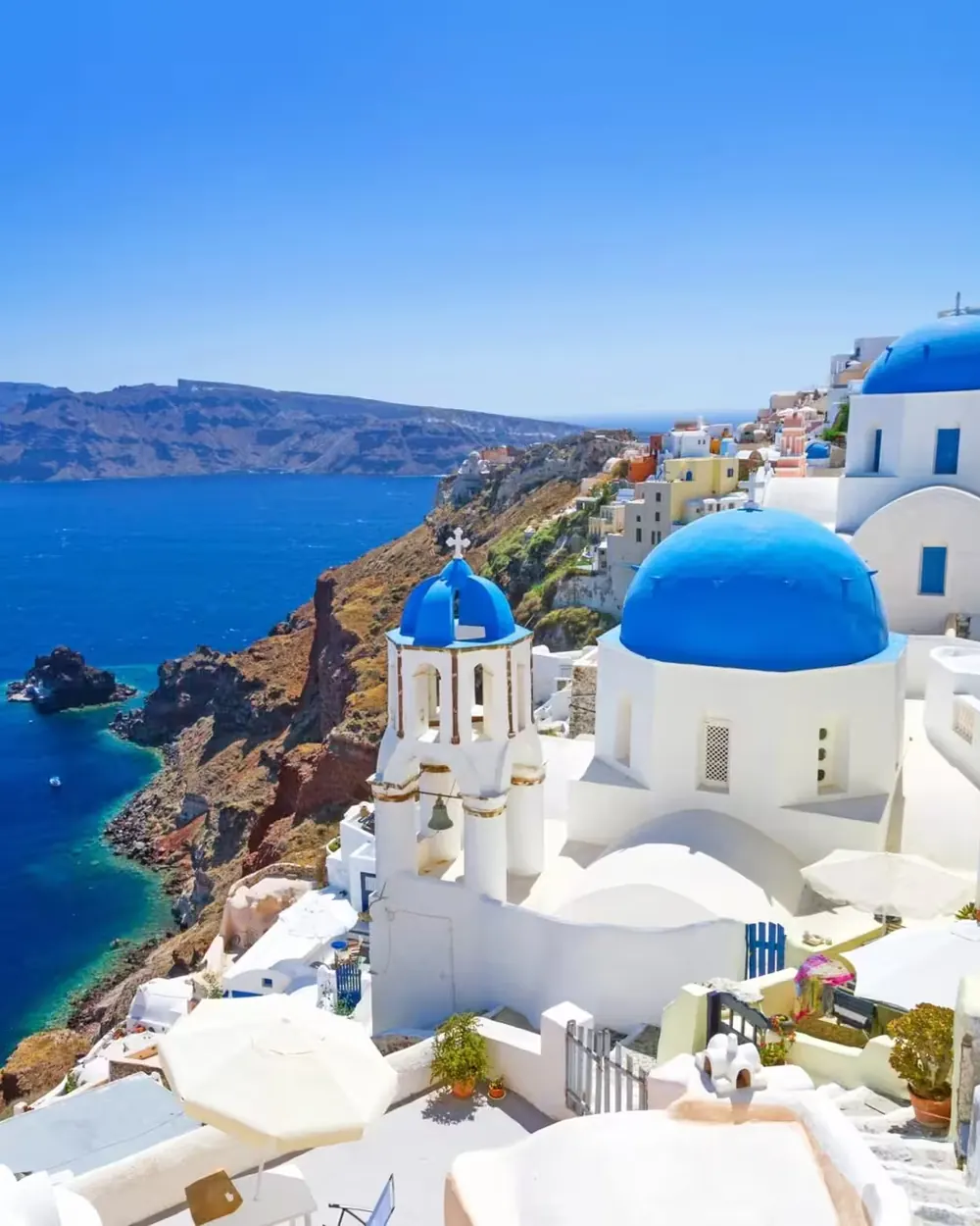 Blauwe koepels boven de caldera van Santorini
